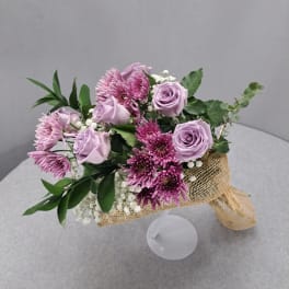 Lavender roses and purple chrysanthemums in burlap wrap