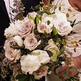 Bouquet of pale pink and white roses with greenery