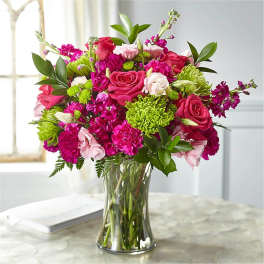 Pink and green mixed bouquet in a clear glass vase
