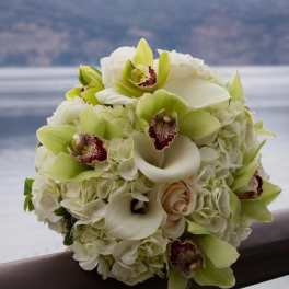 Bouquet of white calla lilies, orchids, and hydrangeas