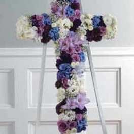 Cross-shaped floral arrangement in purple, blue, and white flowers