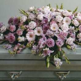 Lavender and white floral casket spray with roses and daisies