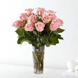 Pink roses arranged in a clear glass vase