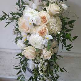 White and cream floral arrangement with roses and hydrangeas