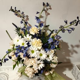 Bouquet of white daisies and cream roses with blue flowers