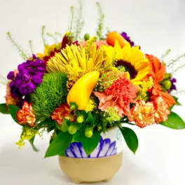 Bright mixed flower arrangement in a decorative vase
