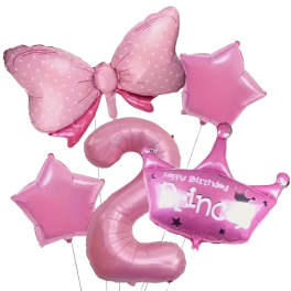 Pink birthday balloons including stars, a bow, and a crown
