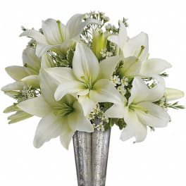 White lilies arranged in a silver vase