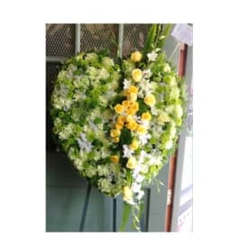 Heart-shaped floral wreath with yellow and white flowers