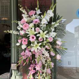 Large standing spray of pink and white flowers on an easel