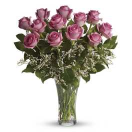 Pink roses arranged in a clear glass vase