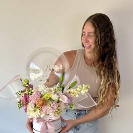 Birthday flower arrangement with a clear balloon and pink ribbon in a white box
