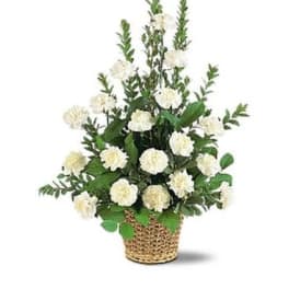 White carnation arrangement in a woven basket