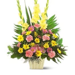 Tall mixed flower arrangement in a gold vase with yellow and pink blooms