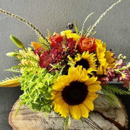 Mixed bouquet with sunflowers, roses, hydrangea, and lilies