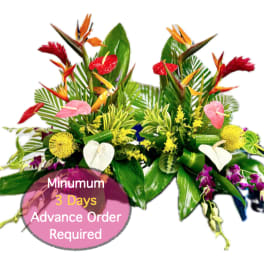 Tropical floral arrangement with red, pink, yellow, and white blooms