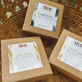 Three boxed body and hand soap bars in a wicker basket