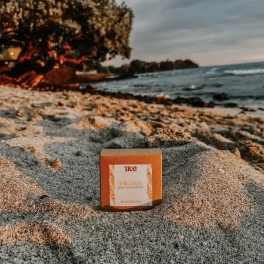 Orange product box on a rocky beach near the water