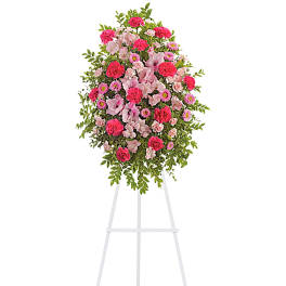 Pink and white floral standing spray on a white easel