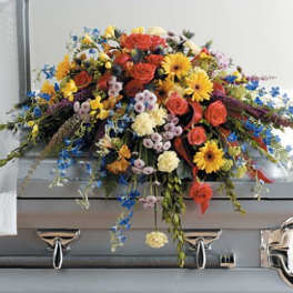 Colorful floral spray on a gray casket