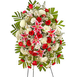 Standing funeral spray with red roses, pink lilies, and white flowers