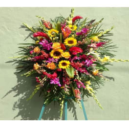 Large colorful standing floral spray with sunflowers and orchids