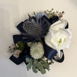 Small boutonniere with white blooms and navy ribbon