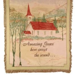Framed wall hanging with a church scene and the words Amazing Grace