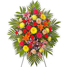 Colorful standing floral spray with lilies, roses, and daisies