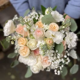 Bouquet of blush and white roses with white blooms and eucalyptus
