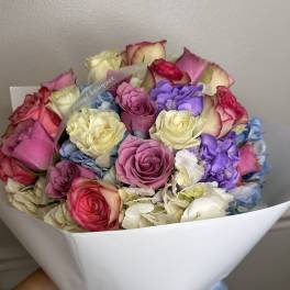 Bouquet of multicolored roses wrapped in white paper