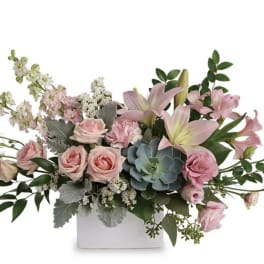 Pink roses and lilies in a white rectangular vase