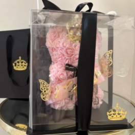 Pink rose teddy bear in a clear gift box with black ribbon
