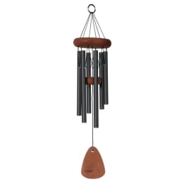 Black metal and wood wind chime with hanging clapper on white background