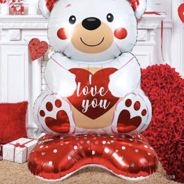 Large teddy bear balloon holding a heart with "love you" text