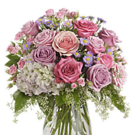Pink and lavender rose bouquet in a clear glass vase