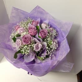 Lavender rose bouquet wrapped in purple paper