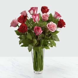 Bouquet of red and pink roses in a clear glass vase