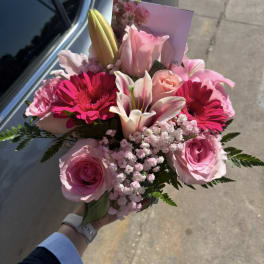 Pink bouquet with roses, lilies, and bright gerbera daisies