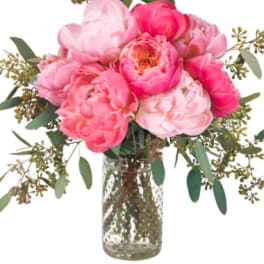 Pink peony bouquet in a clear glass vase