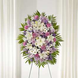 Standing floral spray with pink, white, and lavender flowers on an easel