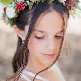 Girl wearing a floral crown with white and pink flowers