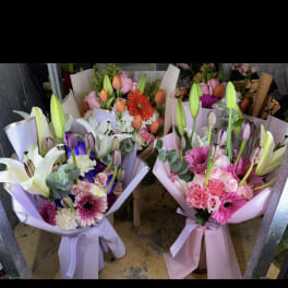 Three pastel mixed bouquets with lilies, tulips, and gerbera daisies