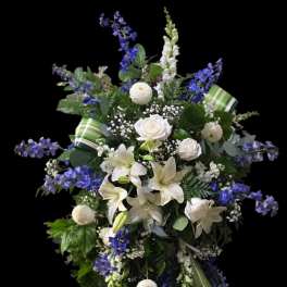 Tall white and blue floral standing spray on an easel