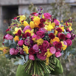 Large bouquet of pink, yellow, and burgundy flowers