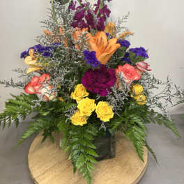 Colorful mixed bouquet in a square glass vase