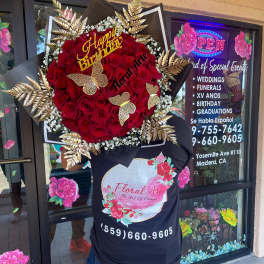 Large red rose bouquet with gold butterfly accents and a Happy Birthday sign