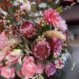 Pink and red mixed bouquet with protea, roses, and lilies