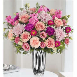 Pink and peach mixed flower arrangement in a silver vase