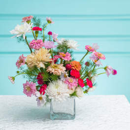 Mixed pink and white flowers in a clear glass vase